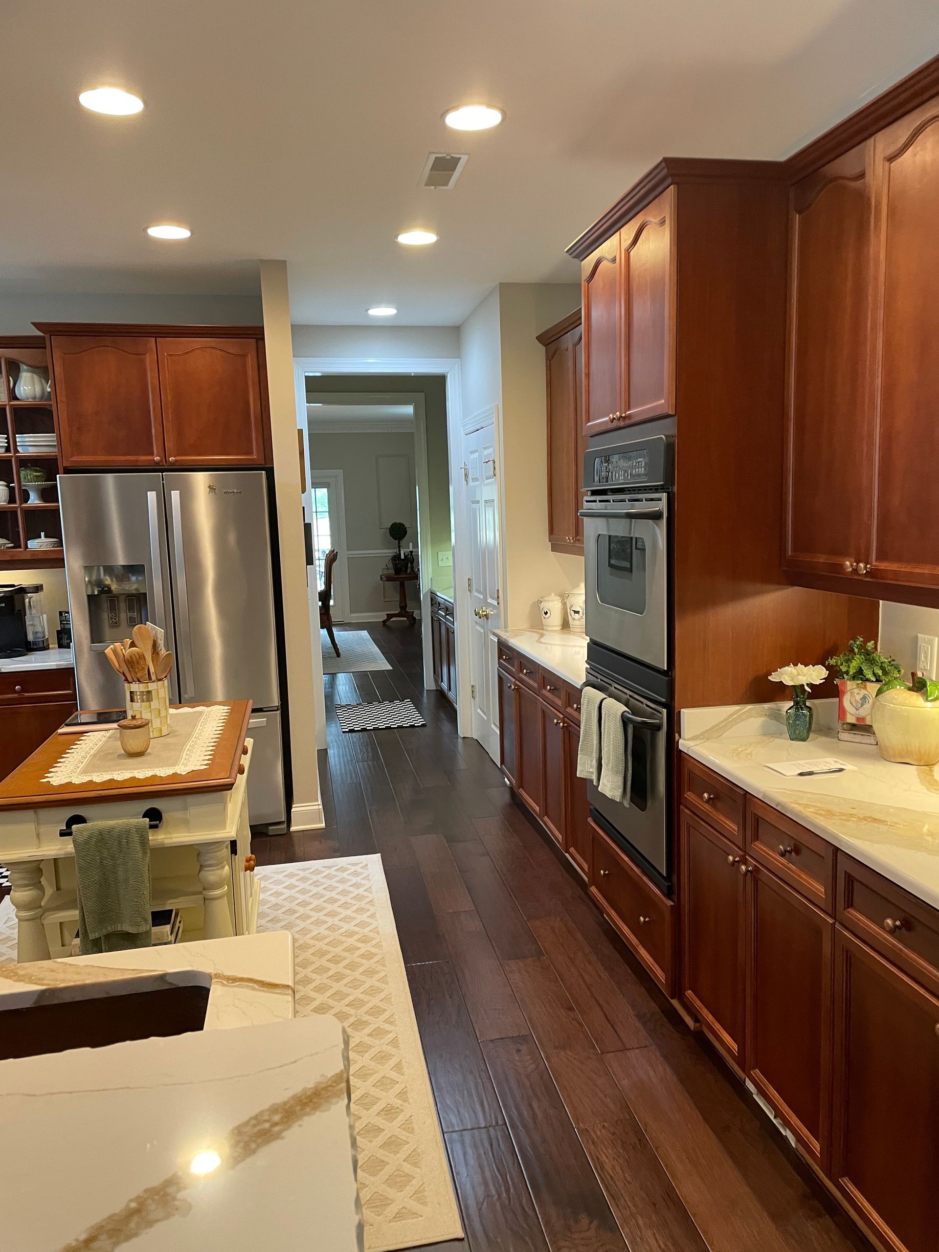 Small laundry room with a washer and dryer, towels draped over them, and an open closet doorway.