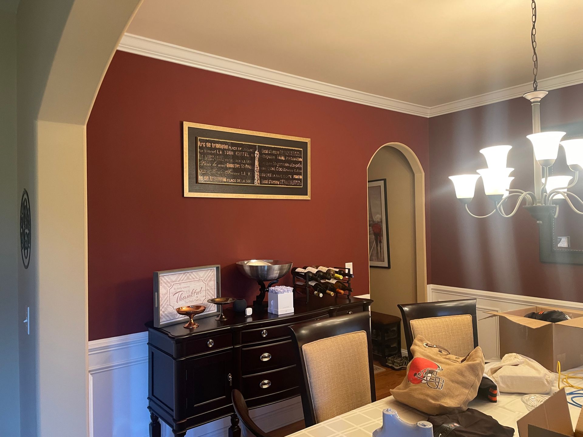 Living room with fireplace and wall star decor; a person bends over near the mantel.