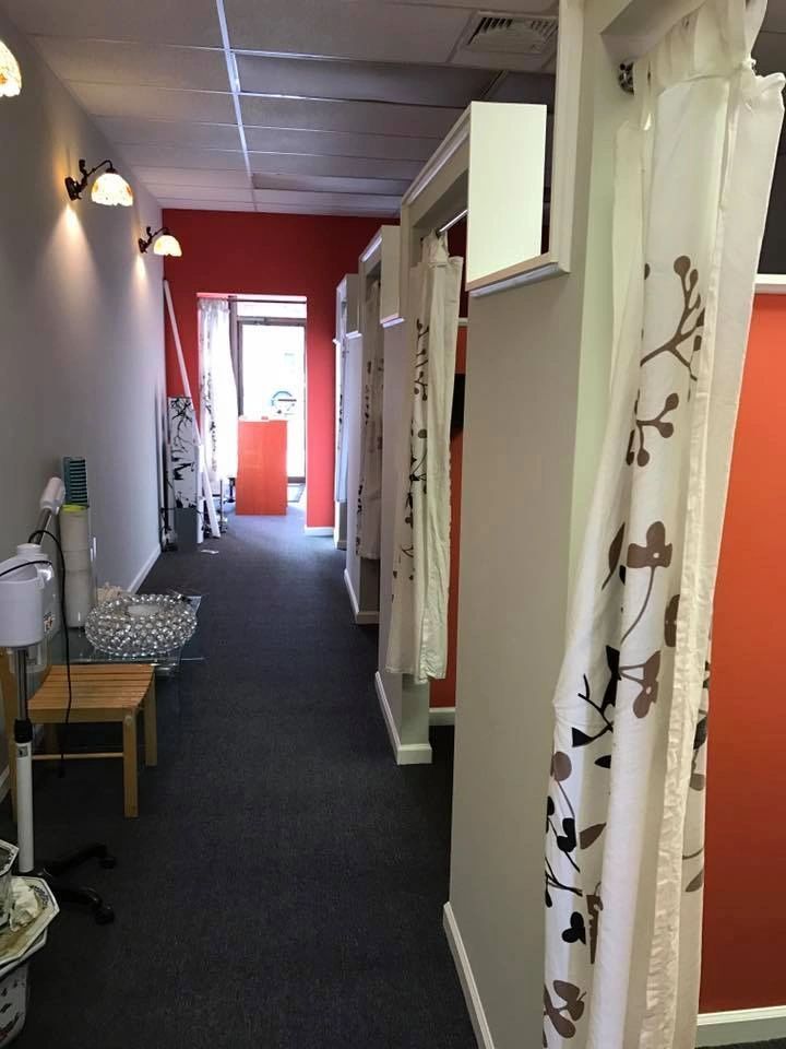 A hallway with red walls and white curtains