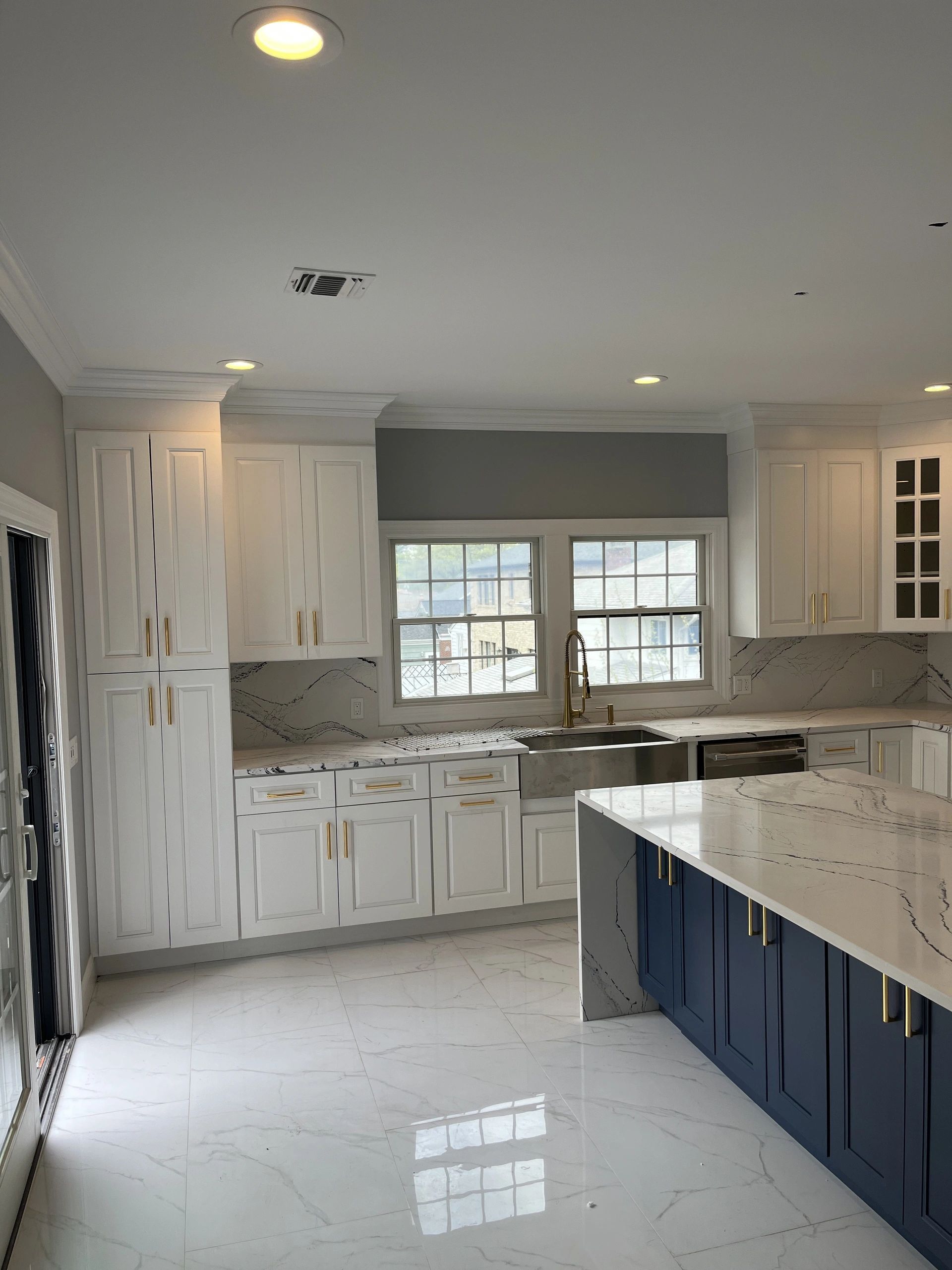 A kitchen with white cabinets and blue counter tops
