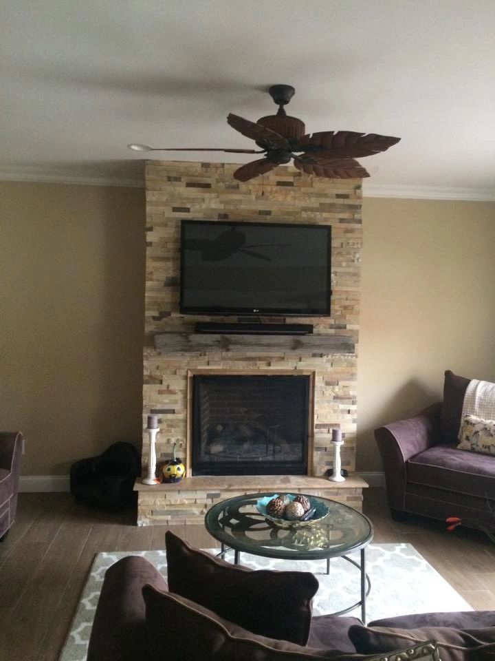 A living room with a fireplace and a flat screen tv