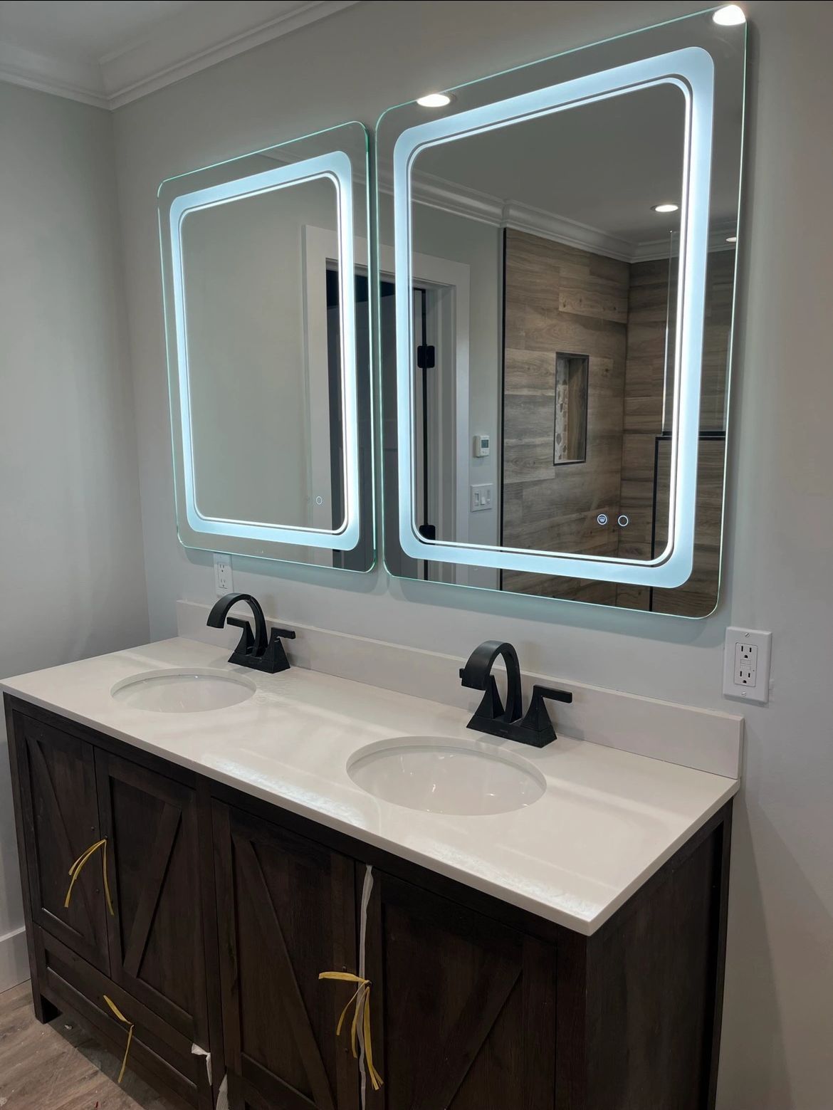 A bathroom with two sinks and two mirrors.