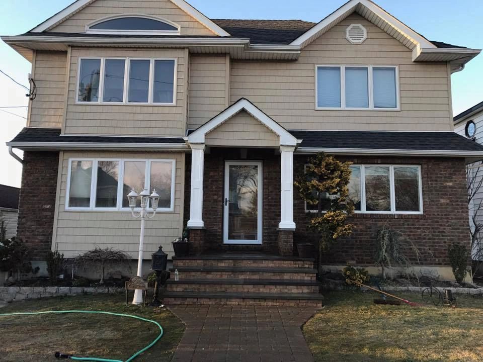 A large house with a hose in front of it.