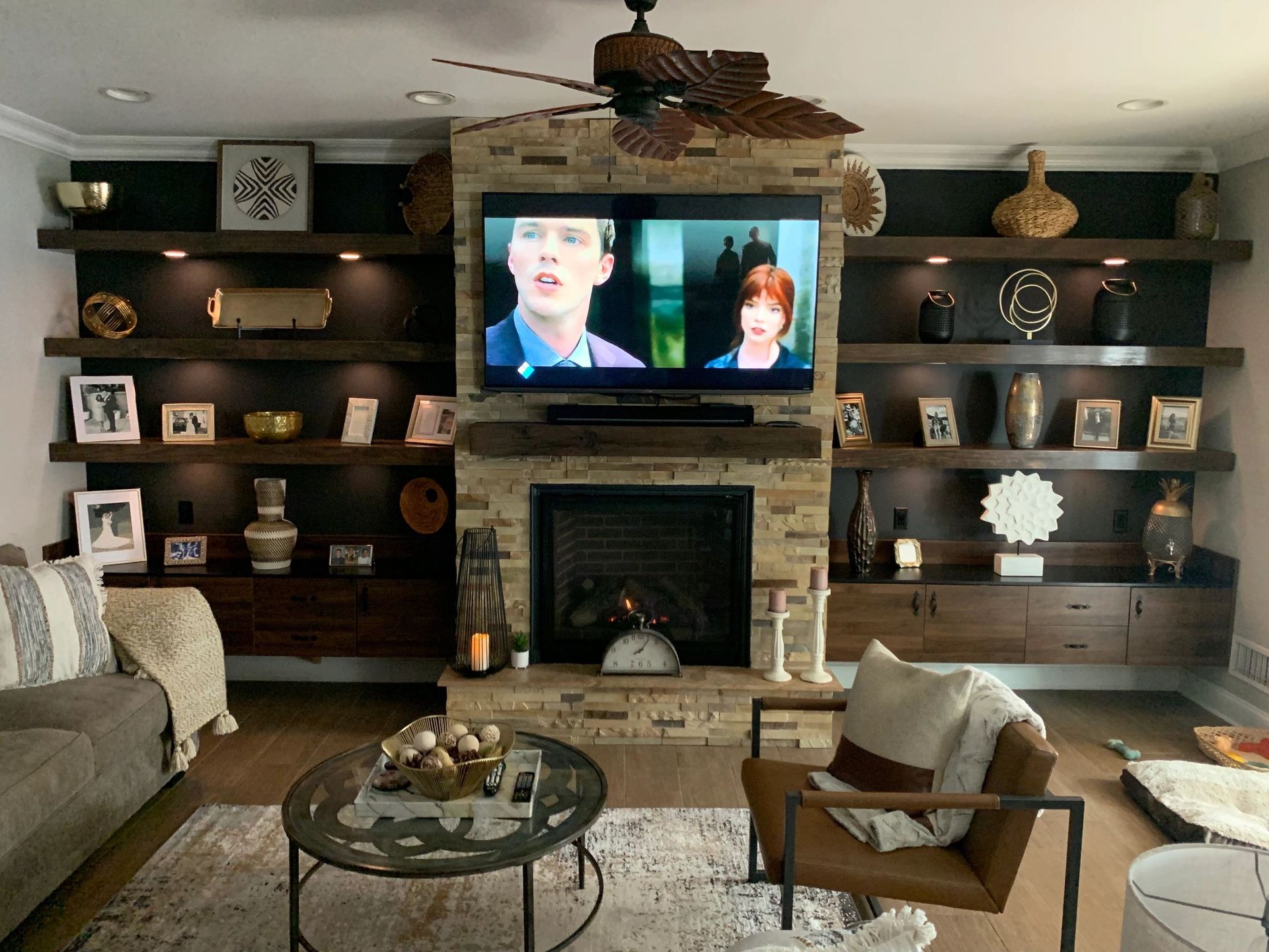 A living room with a fireplace and a flat screen tv