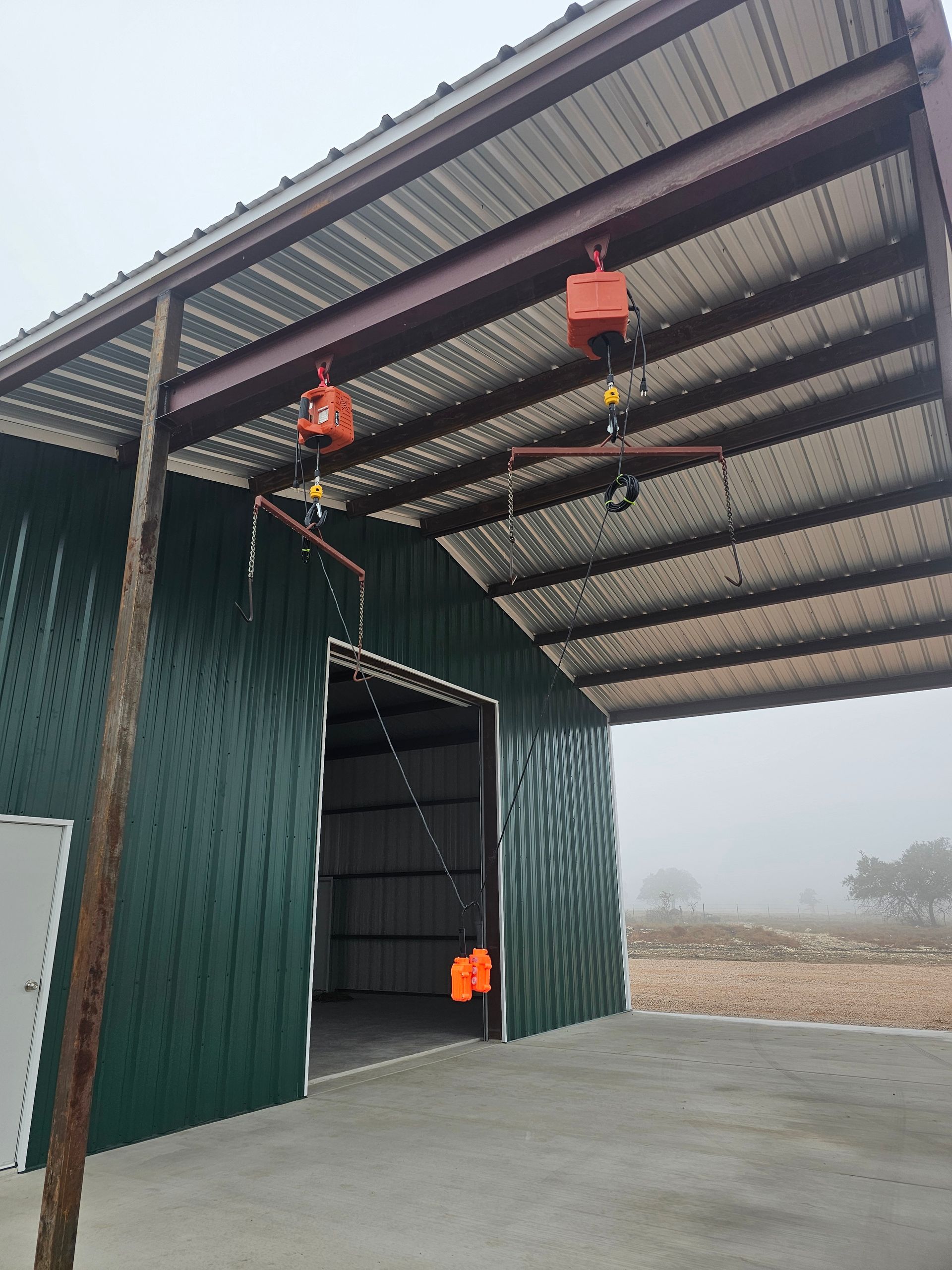 A concrete floor is being built in front of a green building