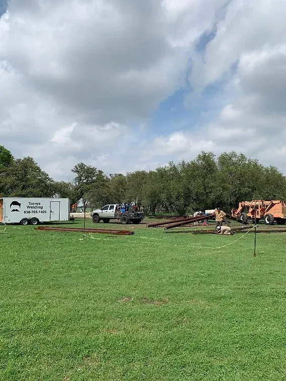 A group of trucks are parked in a grassy field.