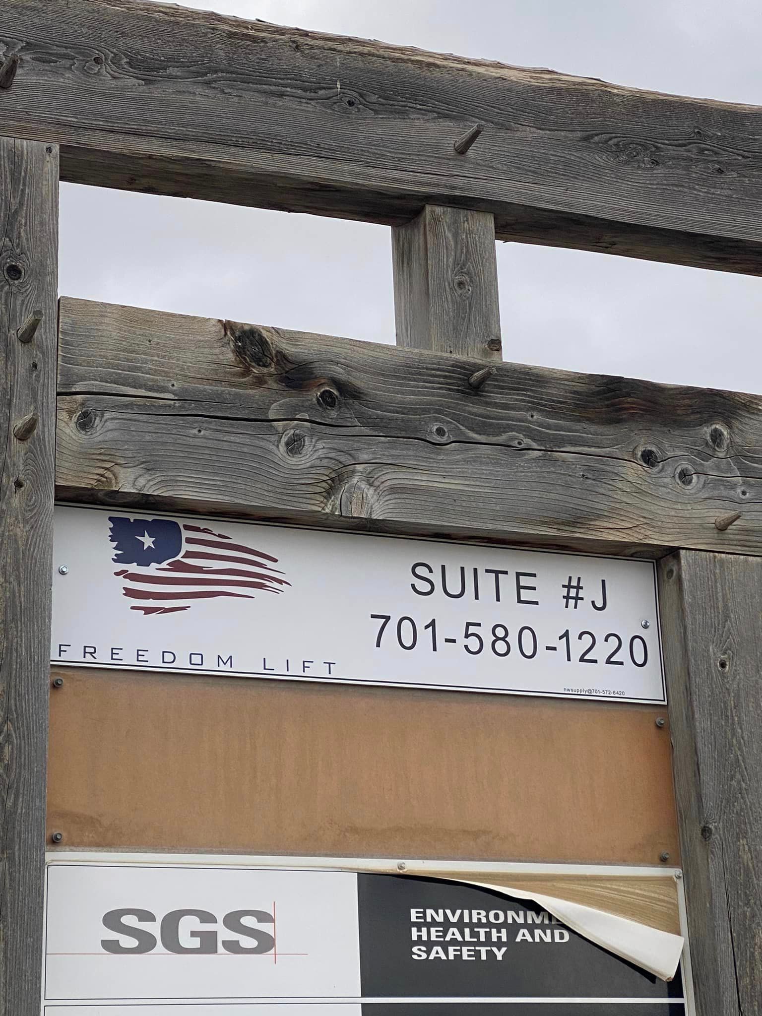 A sgs sign is attached to a wooden structure