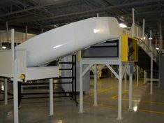 There is a slide in the middle of a warehouse.
