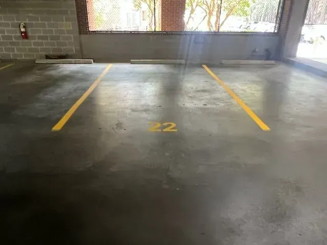 A parking lot with a yellow line and the number 22 painted on it.