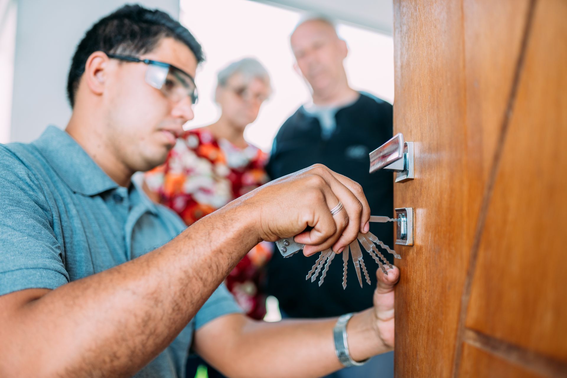 A person is fixing a door with a screwdriver.