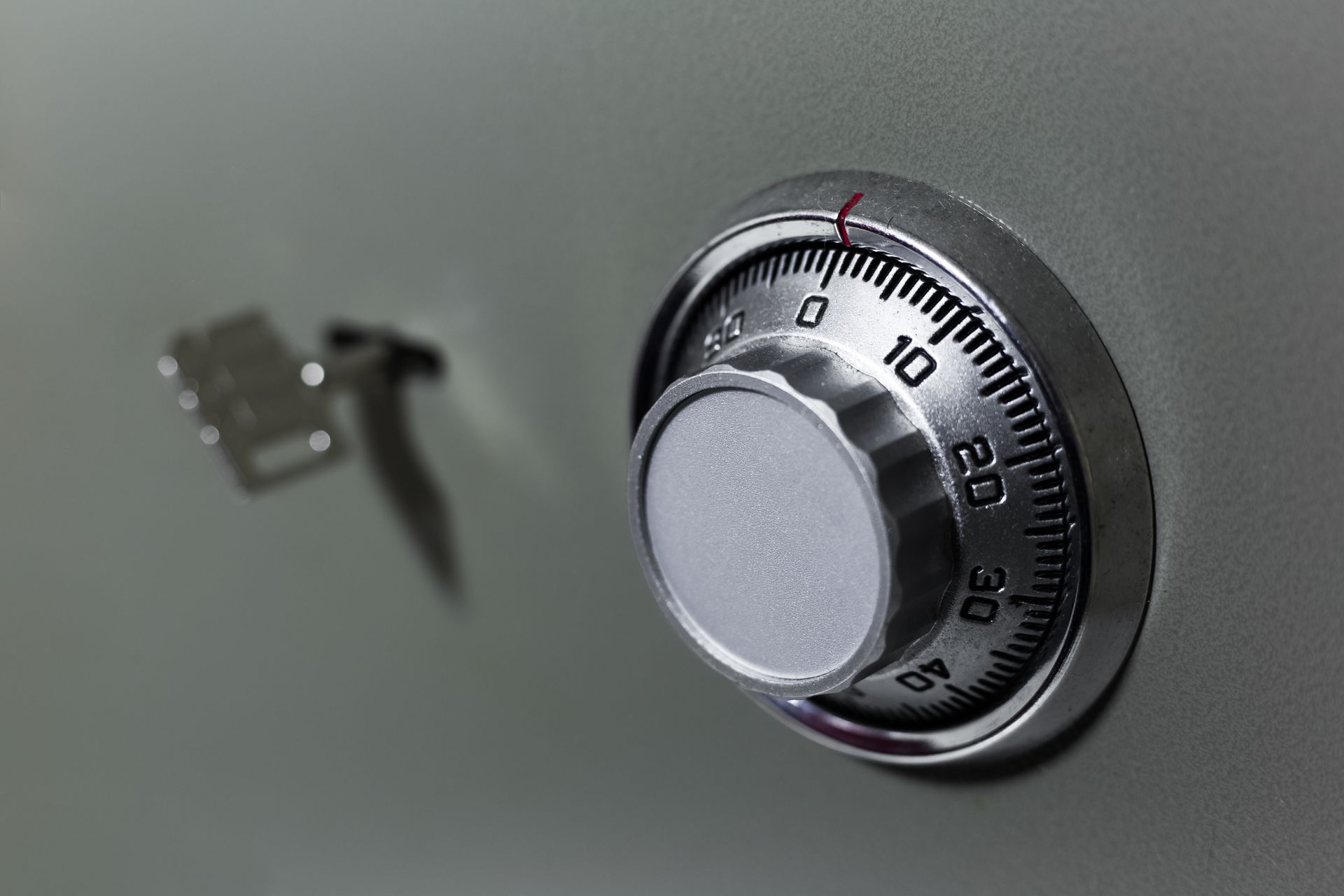 A close up of a combination lock on a safe.