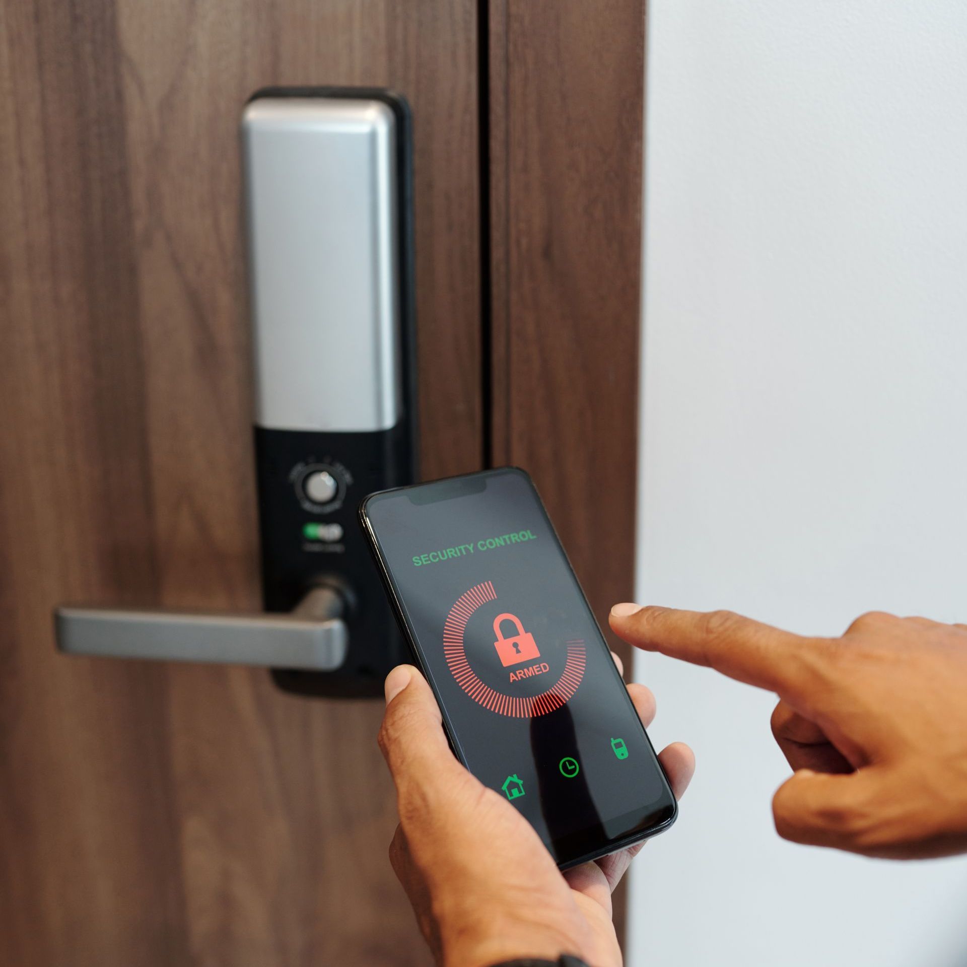 A person is using a smart phone to lock a door.