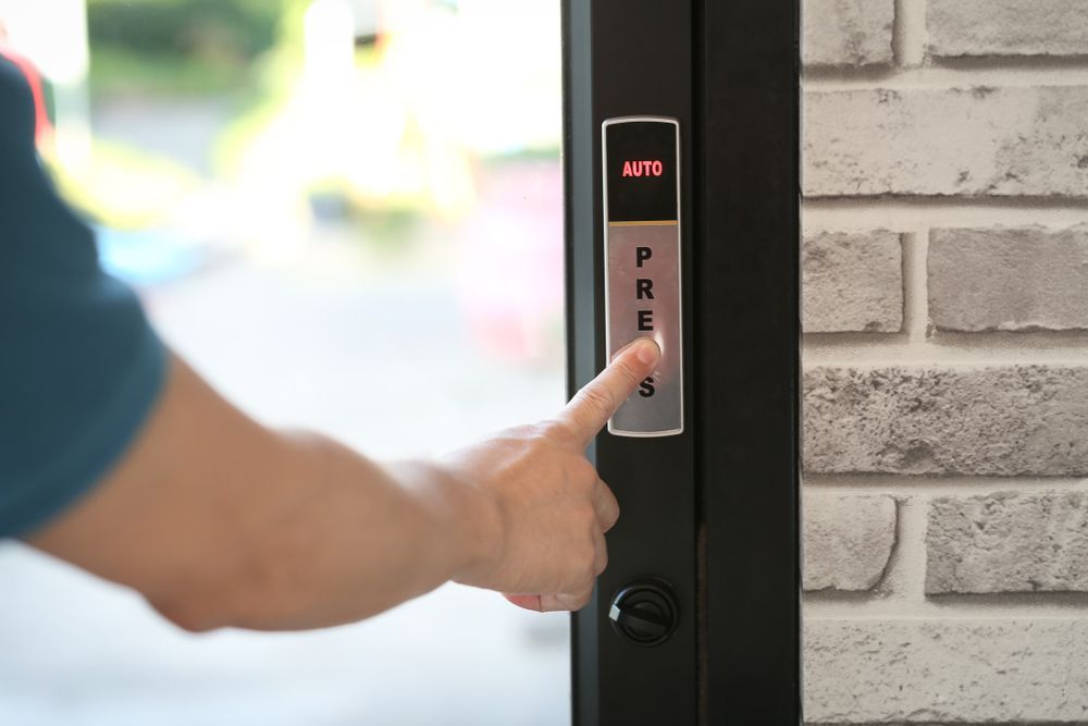 A person is pressing a button on a door lock.