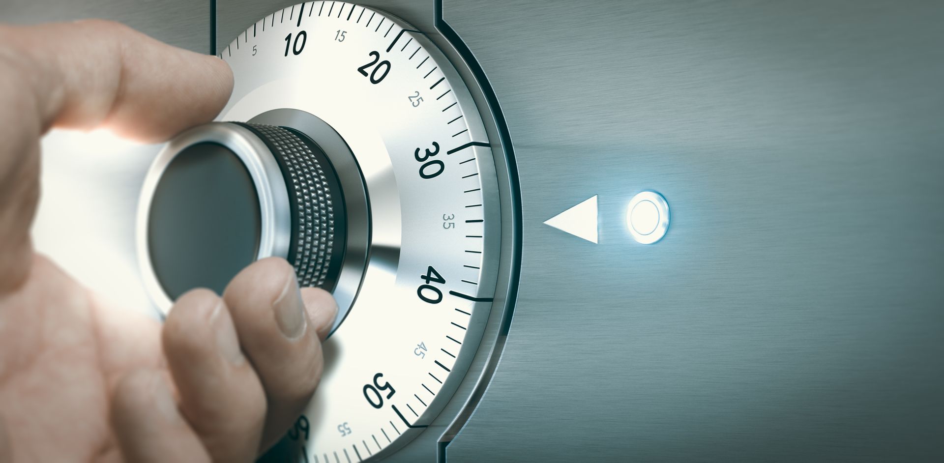 A person 's hand is pressing a button on a safe