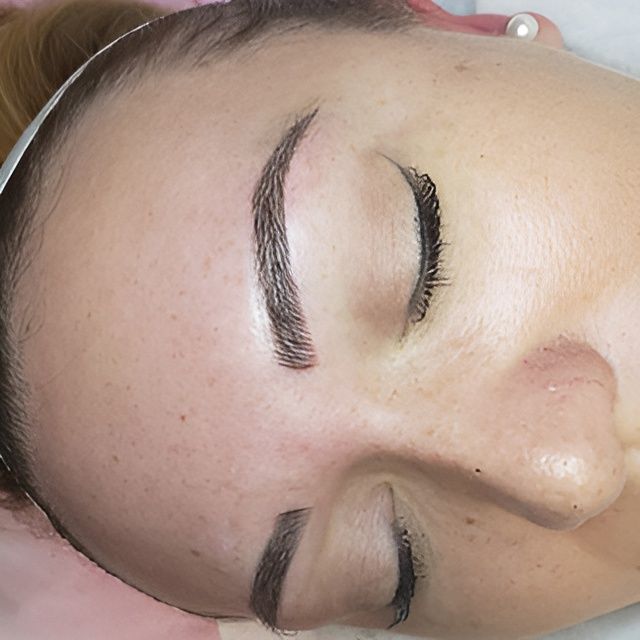 A close up of a woman 's face with her eyes closed