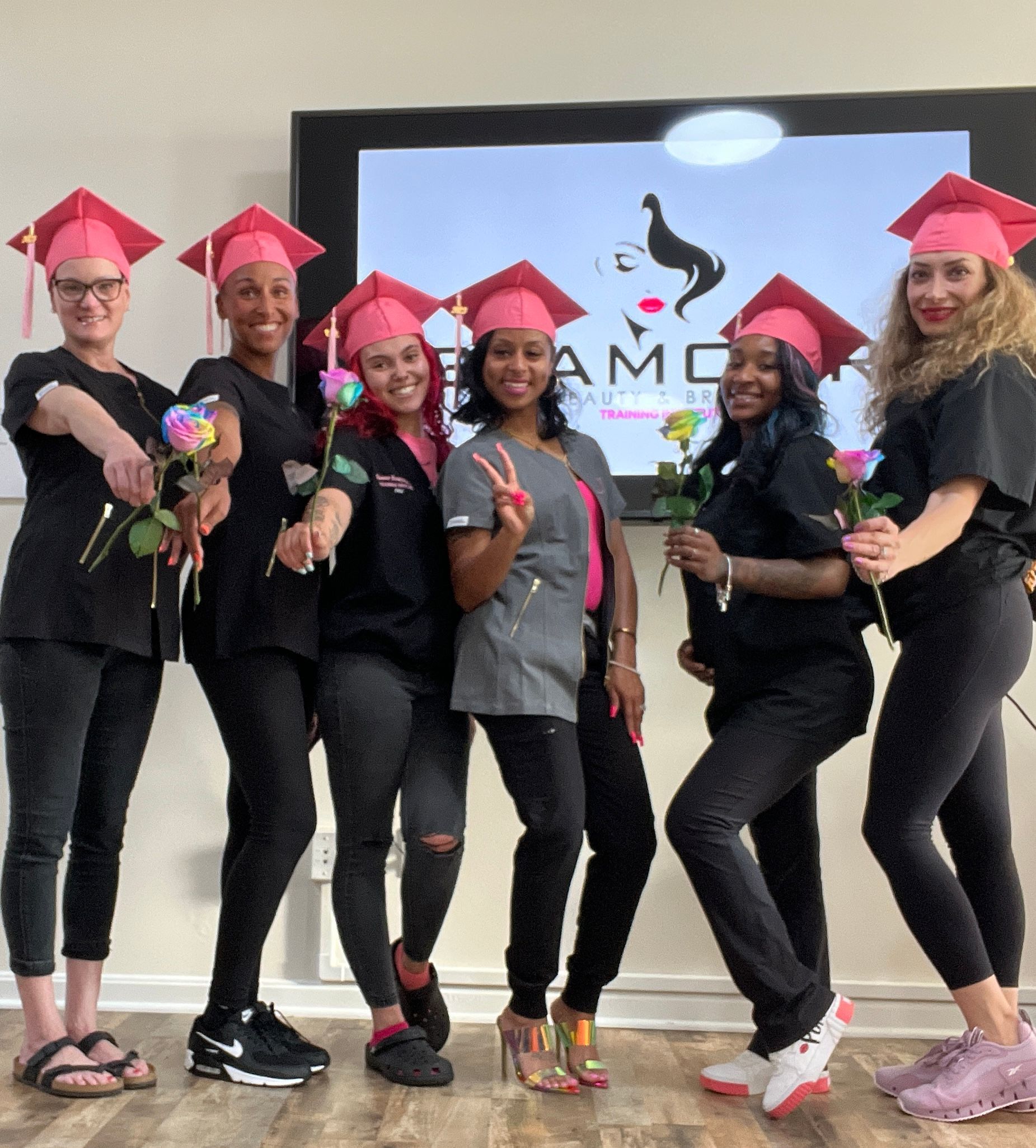 A group of women wearing graduation caps are posing for a picture