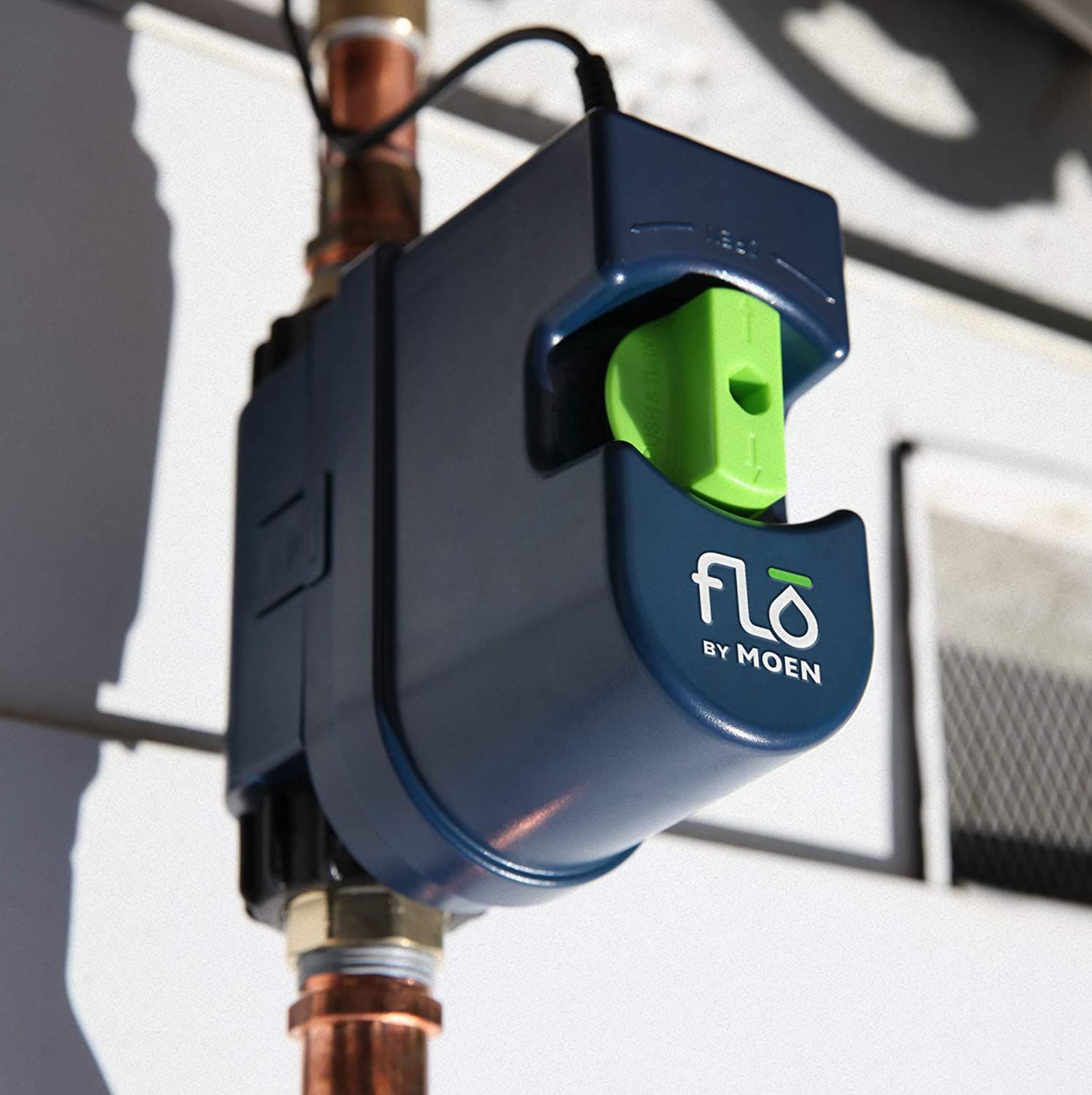 Blue Flo by Moen smart water monitor attached to copper pipes.