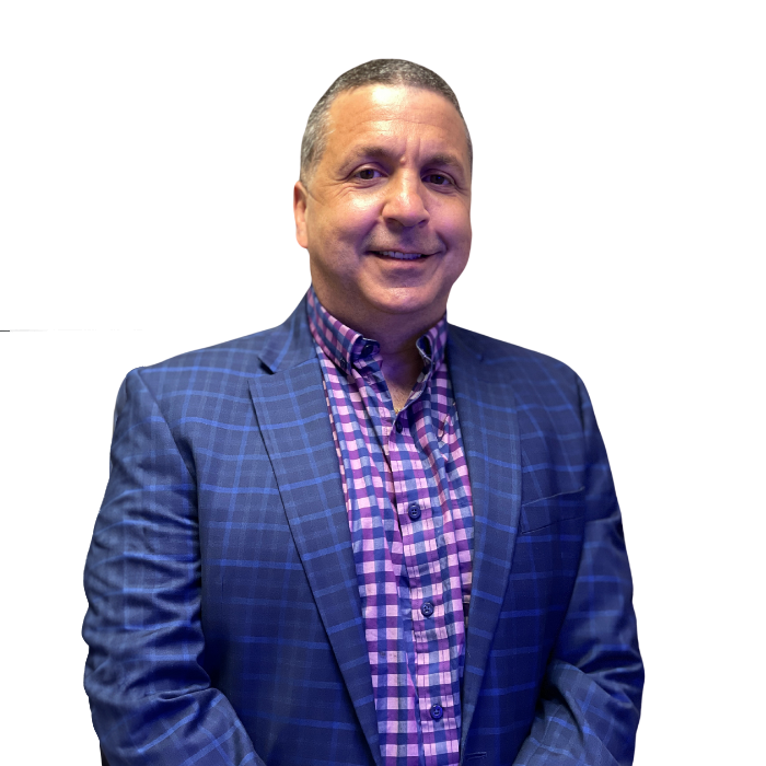 Man in blue blazer and plaid shirt smiles.