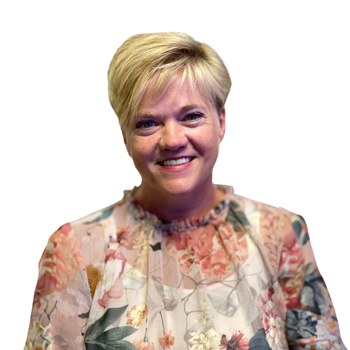 Woman with blonde hair and floral top smiles at the camera.