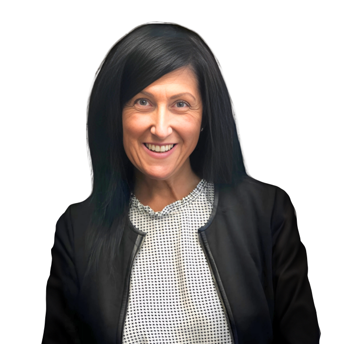 Woman with dark hair smiles, wearing a black jacket over a white and black patterned shirt.