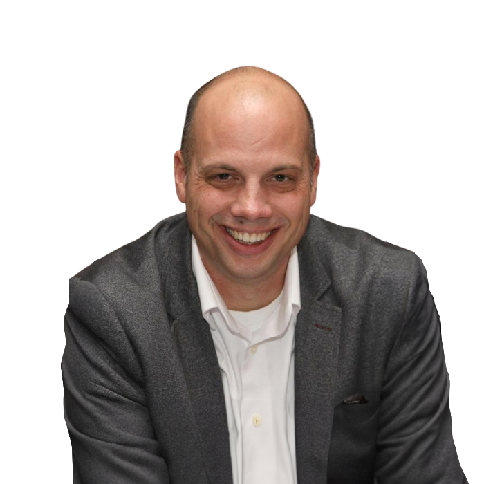 Bald man in gray blazer and white shirt smiling.