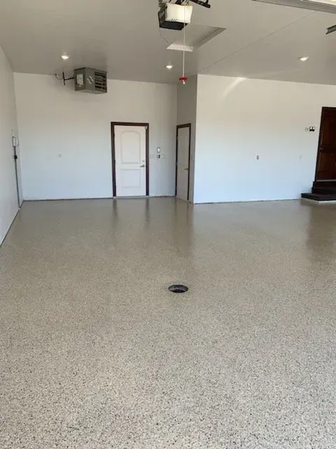 A concrete hallway with a window in the middle