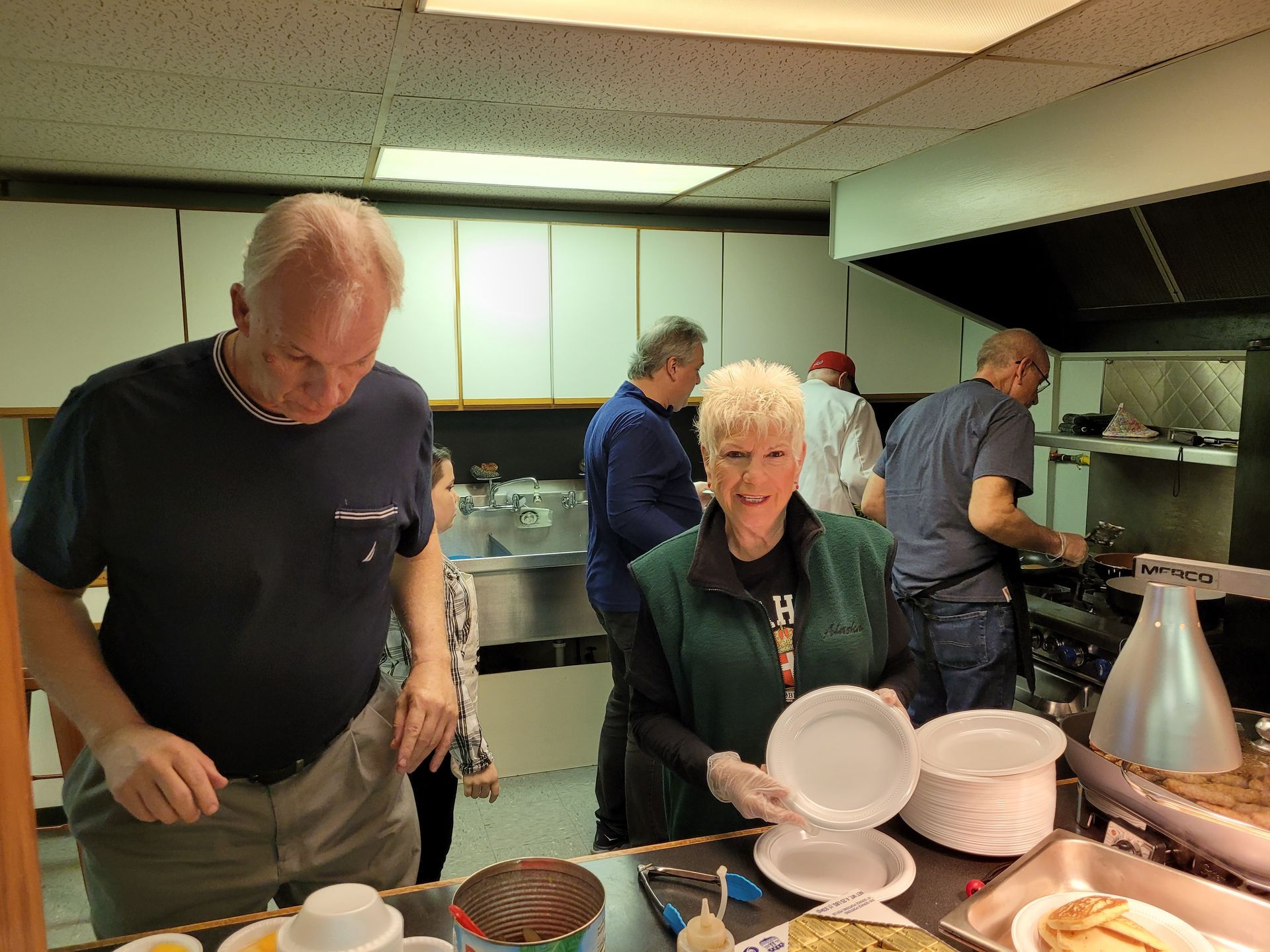 A group of people are preparing food in a kitchen.