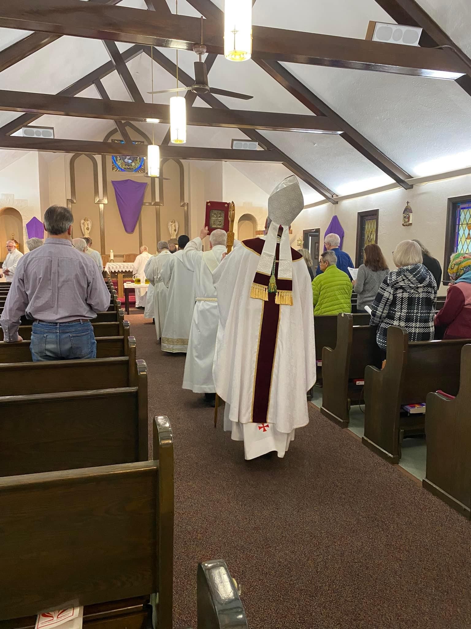 A group of people are standing in a church.