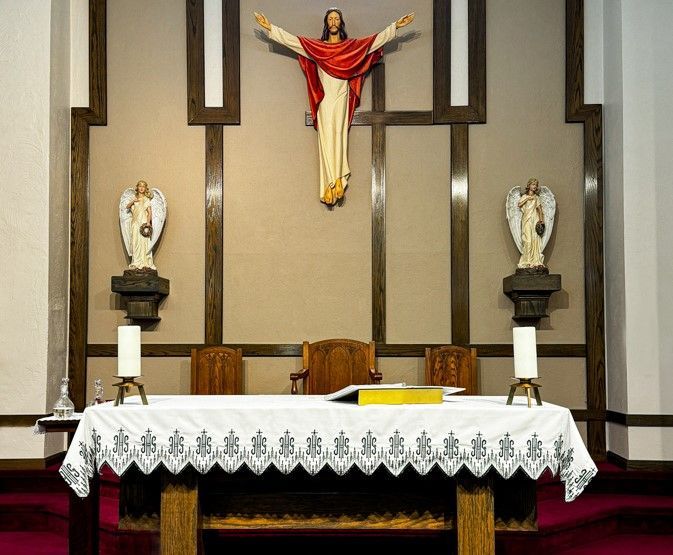 An altar in a church with a statue of jesus on it