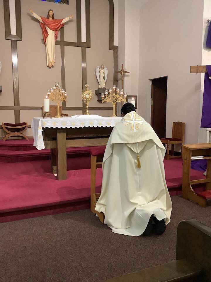 pastor kneeling and praying