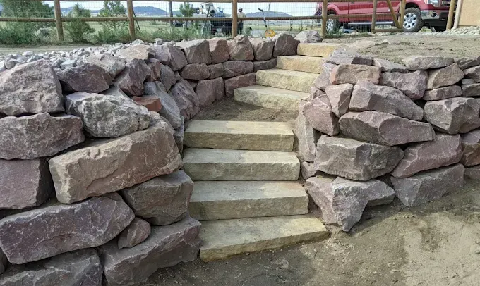 Stone steps ascending between stone retaining walls.