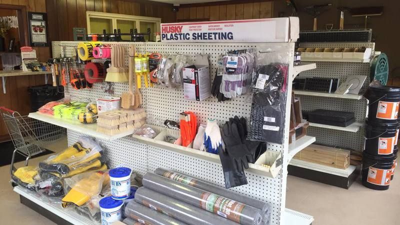 Hardware store interior with shelves of tools and supplies.