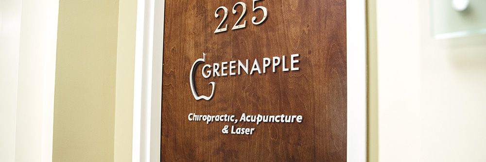 a wooden sign that says greenapple on it