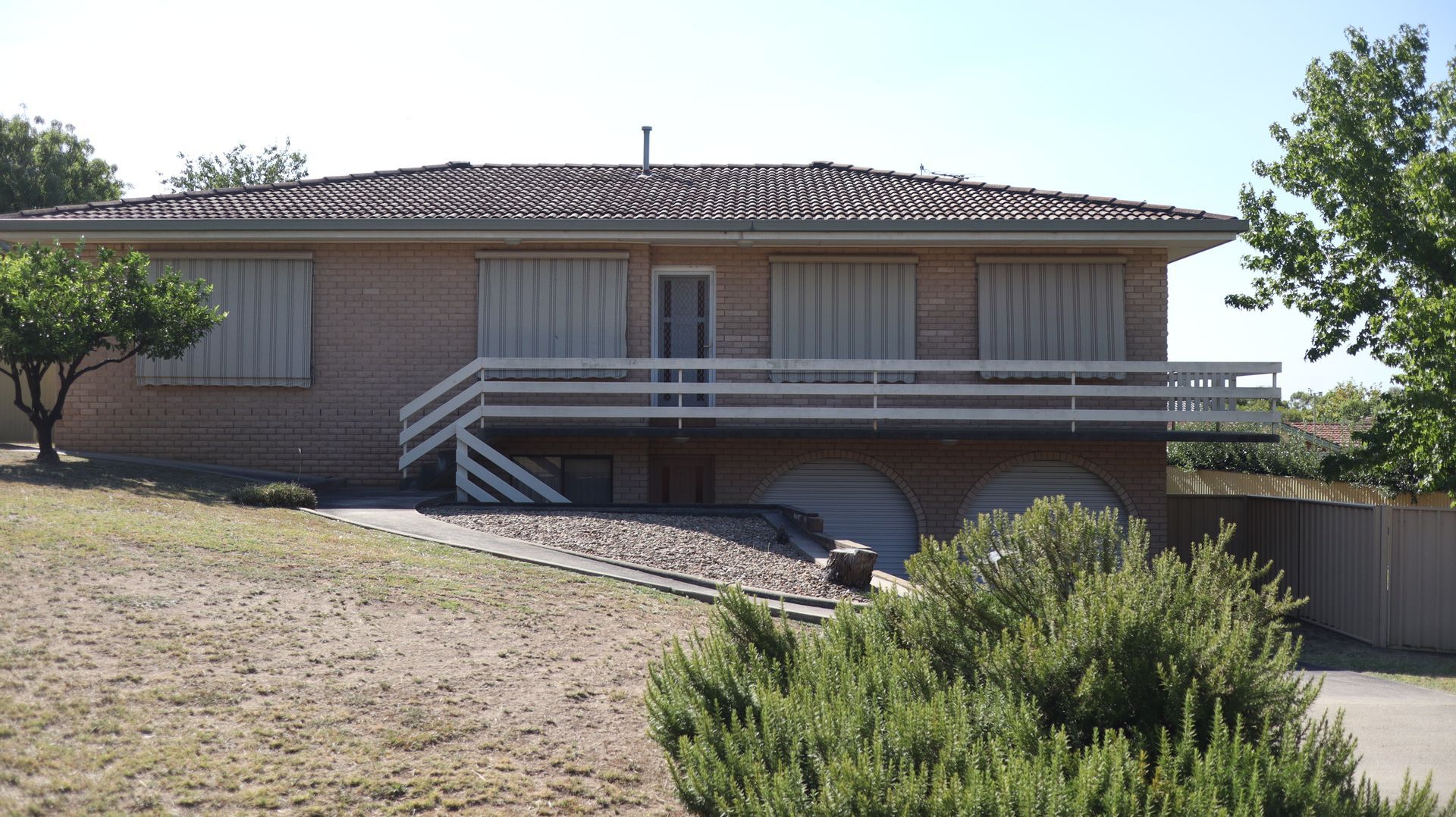 Brick house with white wooden railing— Colombera Constructions In Wodonga, VIC