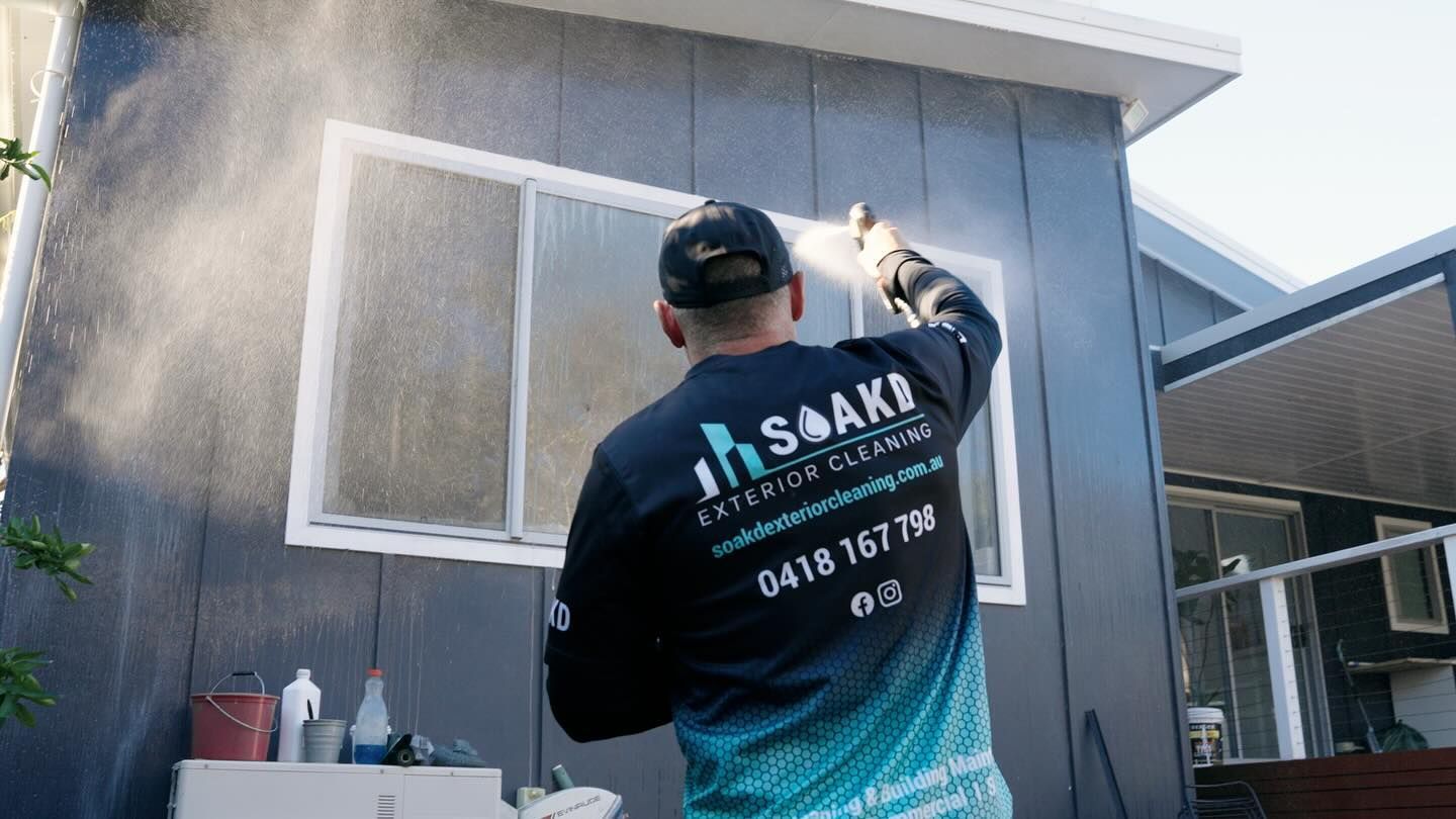 A Man Using A High Pressure Cleaner