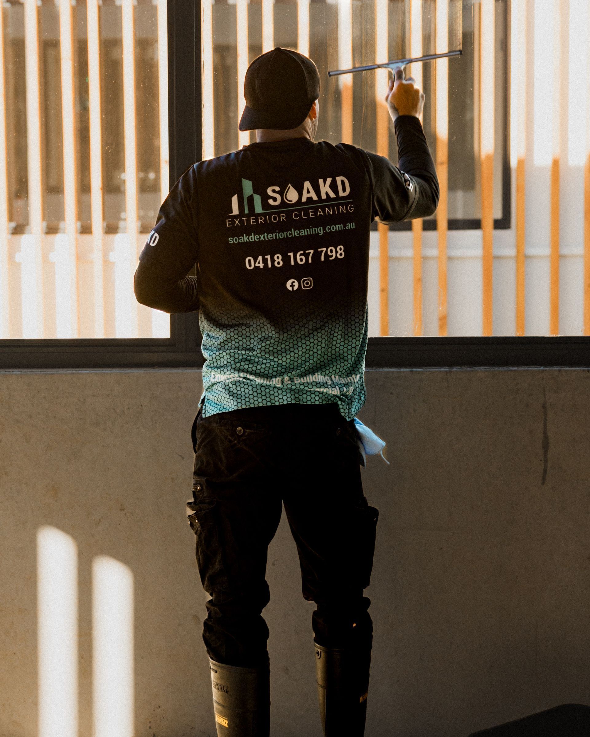 A man is using a high pressure washer to clean a sidewalk. — Soakd In Kariong, NSW