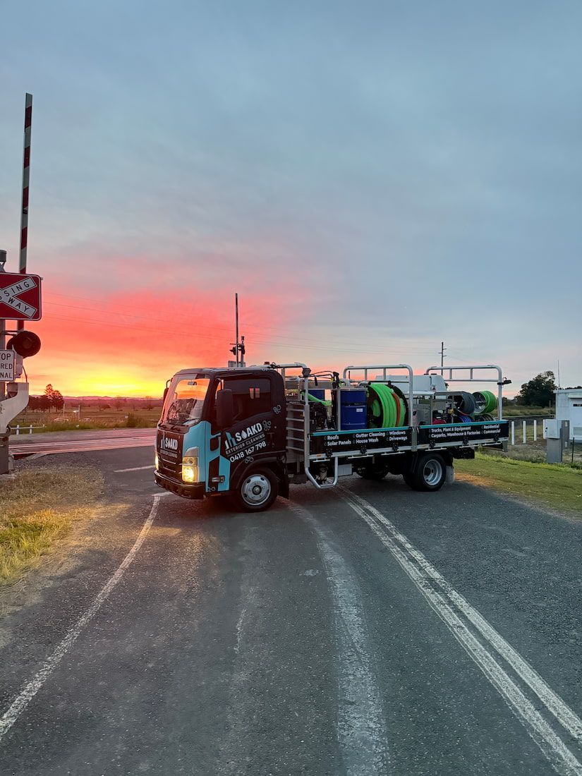 Truck With Spraying Equipment at a Railway Crossing — SOAKD Exterior Cleaning in Belmont, NSW