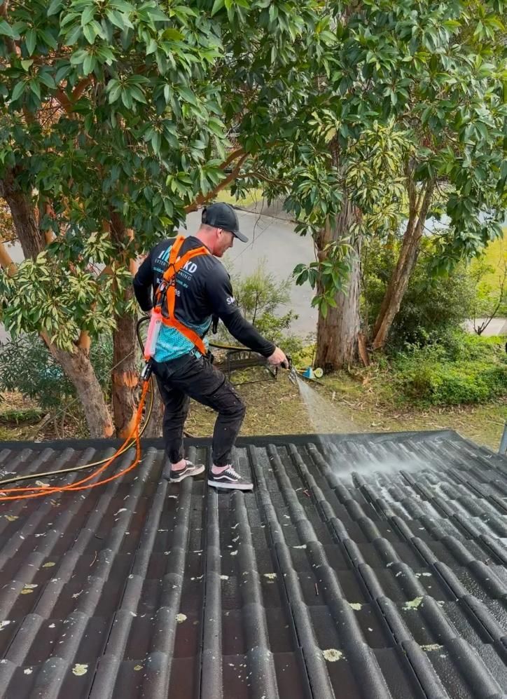 Man Pressure Washing a Dark Tiled Roof — SOAKD Exterior Cleaning in Kariong, NSW