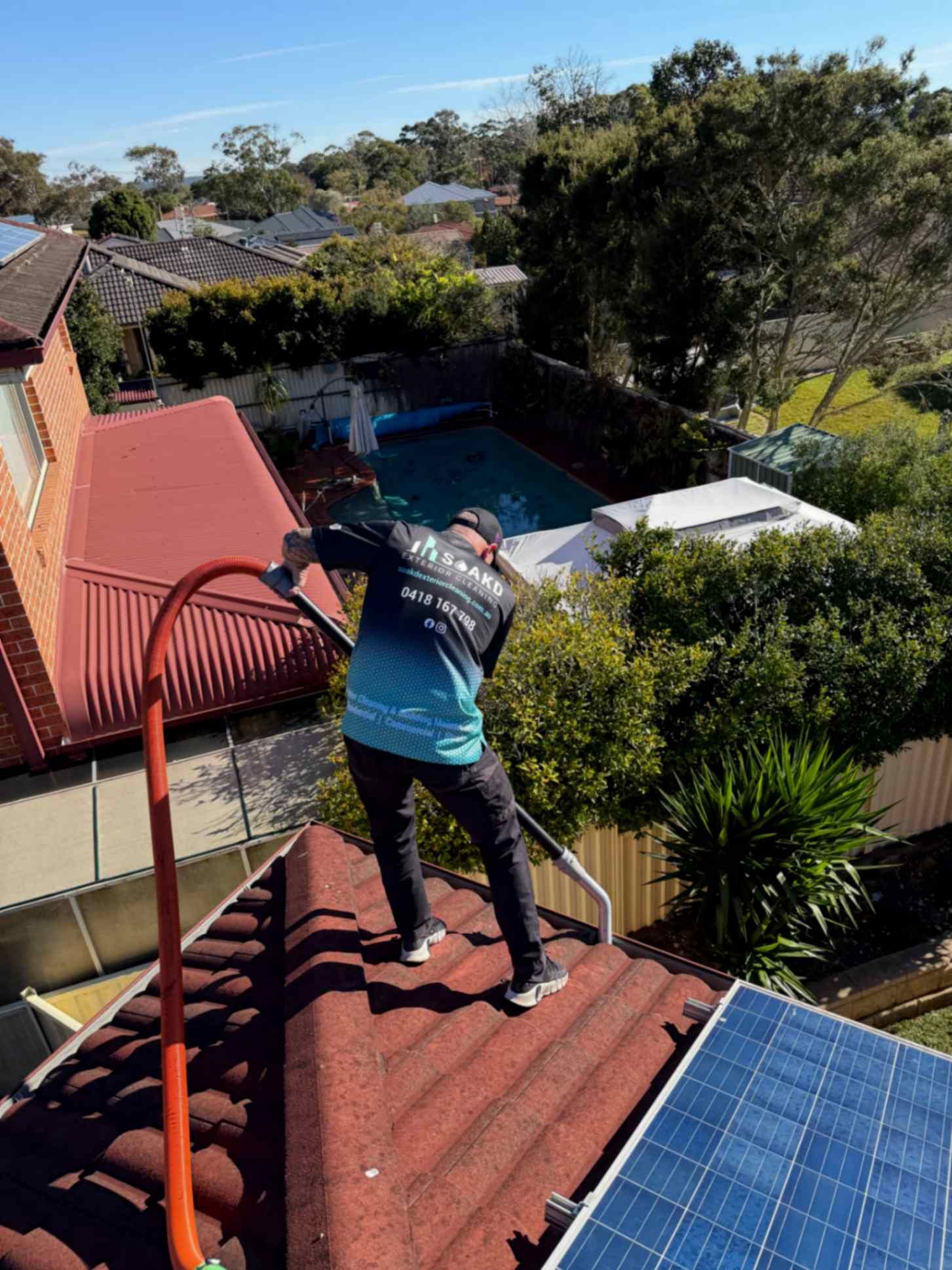 Man Cleaning Gutters Using Tools