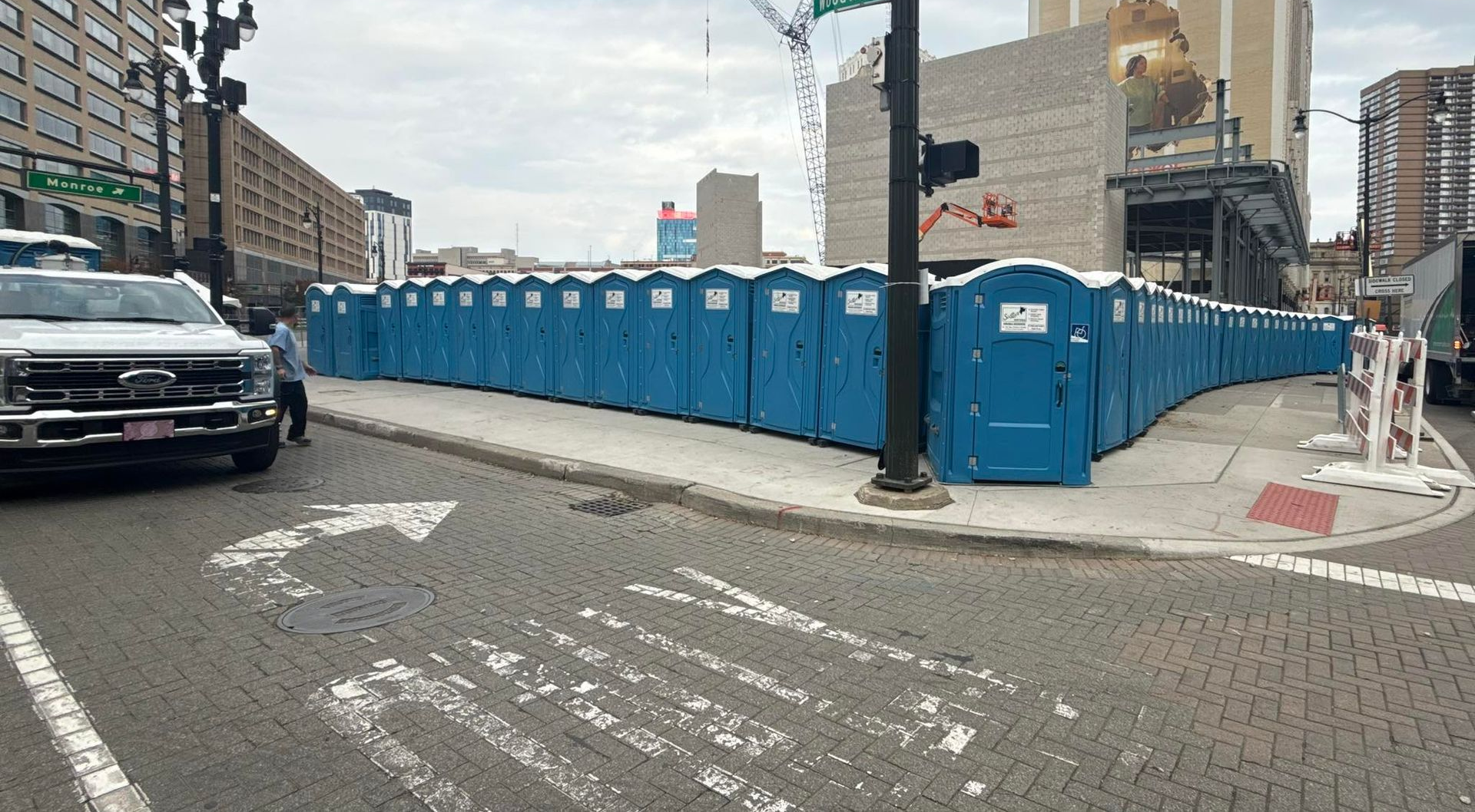 White generator on a trailer with two propane tanks in a workshop setting.