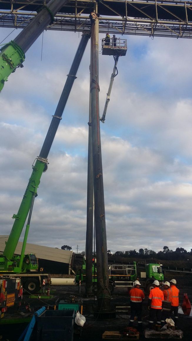 a group of construction workers are working on a trestle