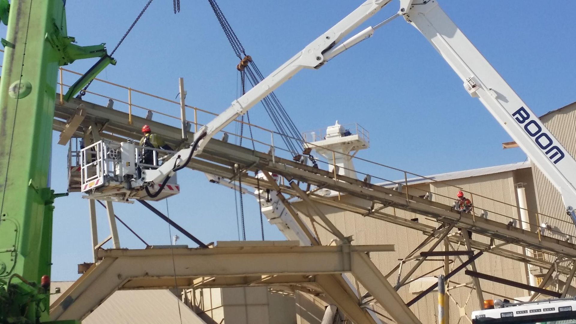 a boom crane is being used to lift a large structure