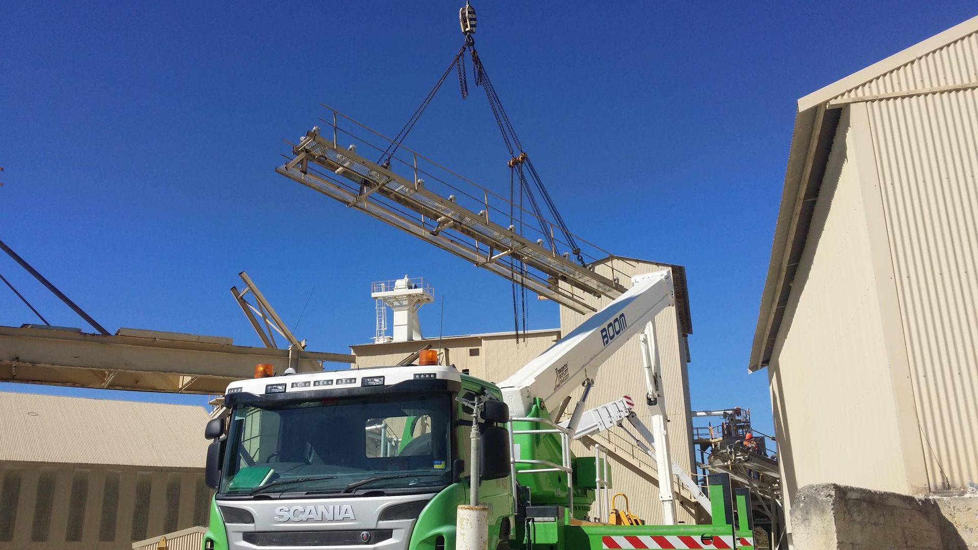 a crane lifting a large piece of metal equipment