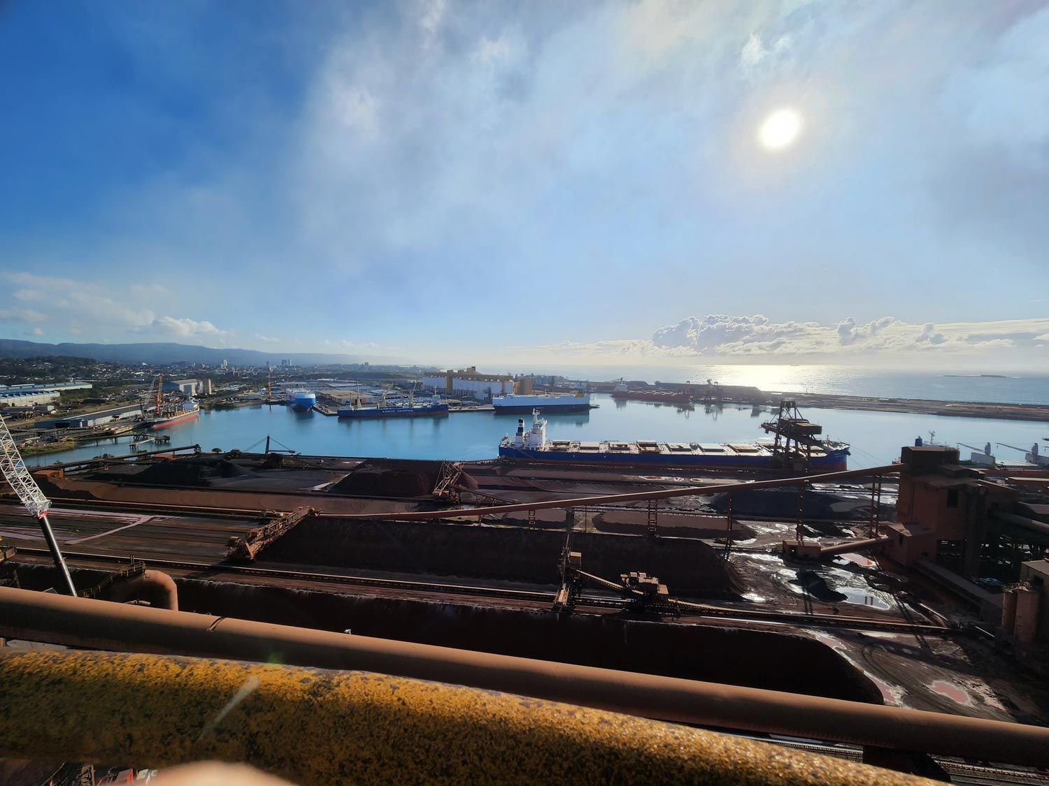 a large body of water beside a factory