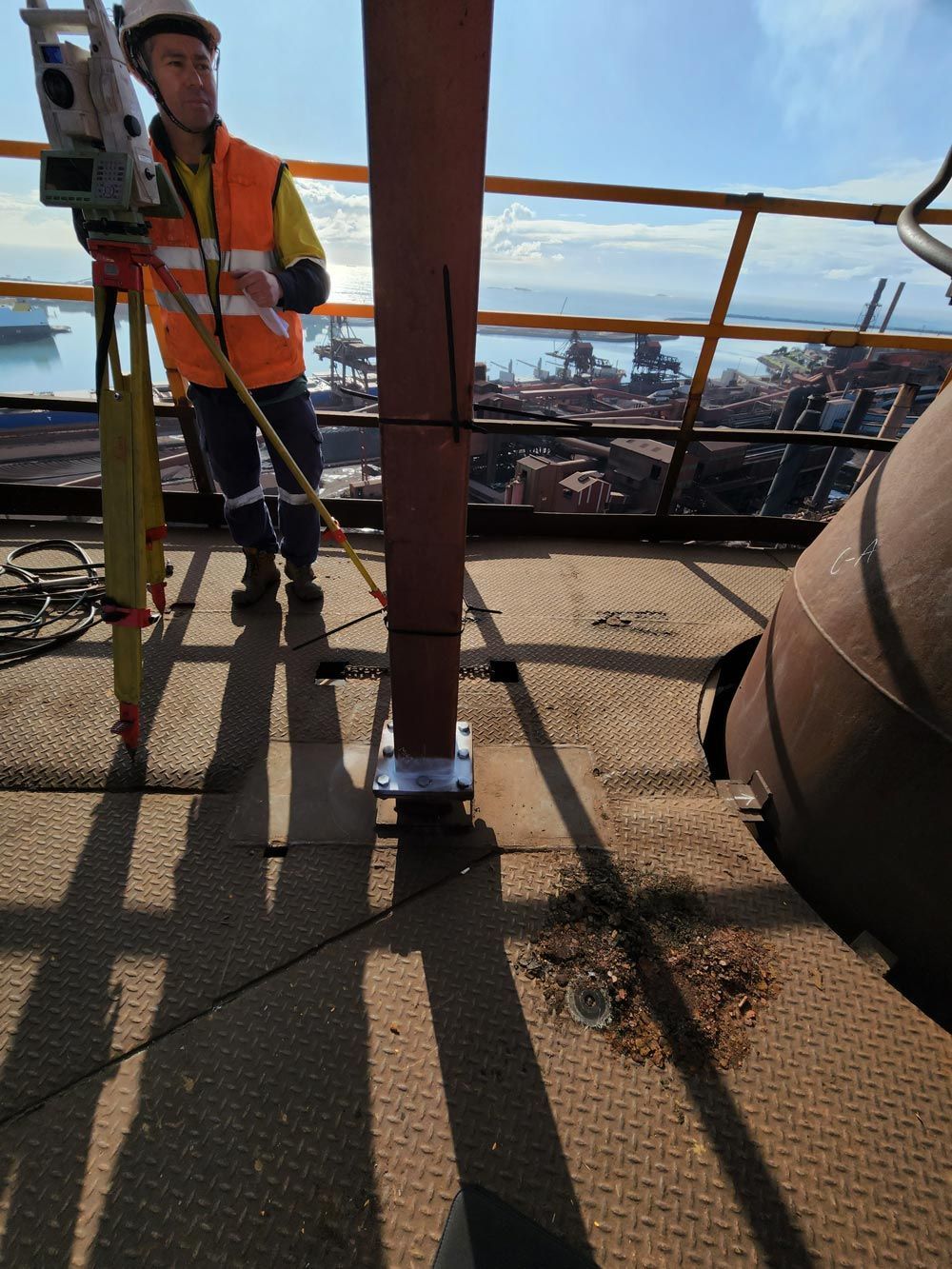 a man is standing on top of a building using a tripod