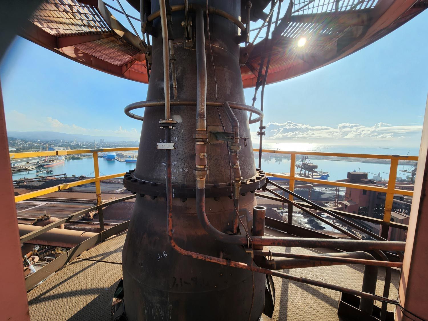 a large metal pipe is sitting on top of a building