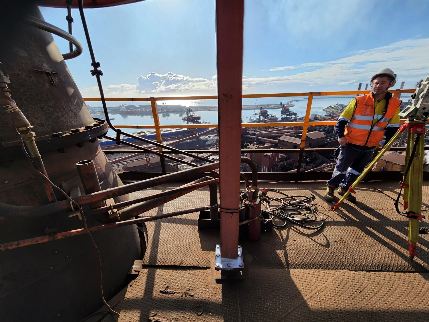 a man is standing on top of a building with a tripod