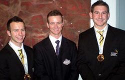 three men in suits and ties are posing for a picture