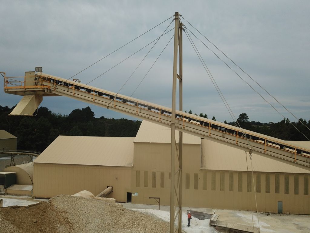 a conveyor belt in front of a large building
