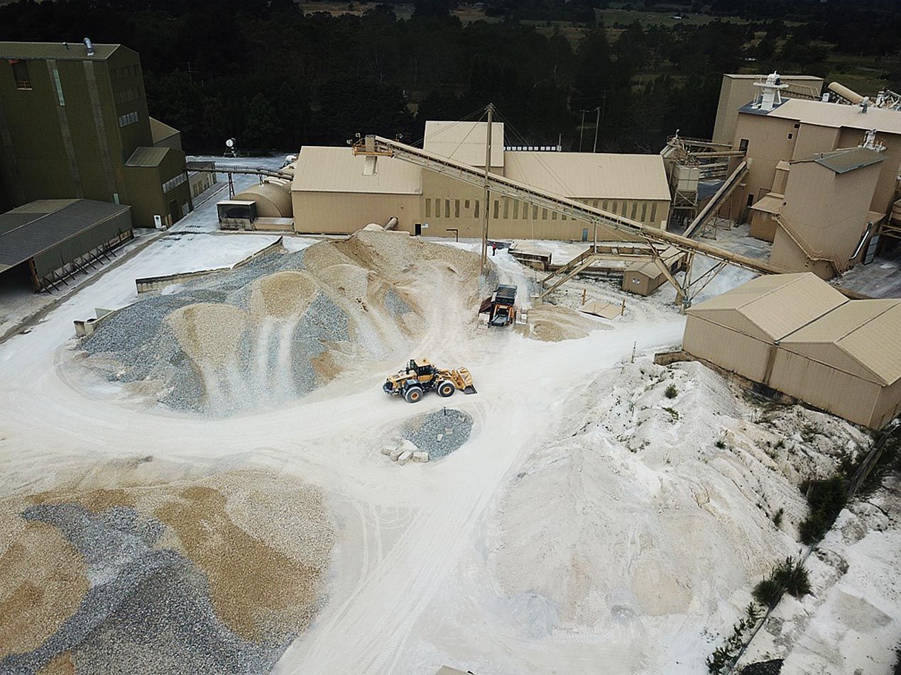 an aerial view of a construction site with a tractor in the foreground